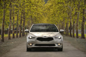 Sleek Kia Cadenza Cruising On A Beautiful Day Wallpaper