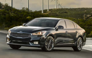 Sleek Kia Cadenza Cruising On A Scenic Highway Wallpaper