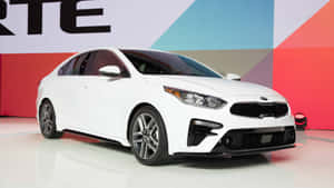 Sleek Kia Forte Gliding On The City Streets Wallpaper