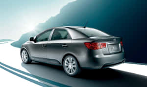 Sleek Kia Forte Sedan Cruising On The Road Wallpaper