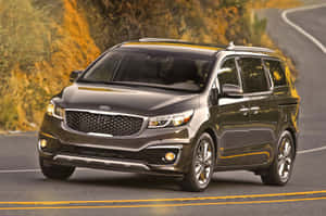 Sleek Kia Sedona Minivan On The Road Wallpaper