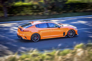 Sleek Kia Stinger In Motion Wallpaper