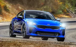 Sleek Kia Stinger On The Open Road Wallpaper