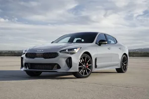 Sleek Kia Stinger Parked On Urban Street Wallpaper