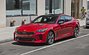 Sleek Kia Stinger Sports Car On The Move Wallpaper