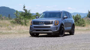 Sleek Kia Telluride On Scenic Road Wallpaper