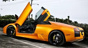 Sleek Lamborghini Murciélago On An Open Road Wallpaper