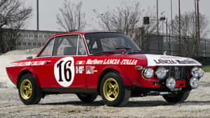 Sleek Lancia Car On A City Street Wallpaper