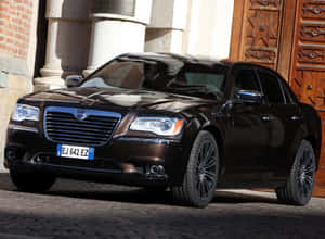 Sleek Lancia Thema In Action Wallpaper