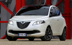 Sleek Lancia Ypsilon In An Urban Setting Wallpaper