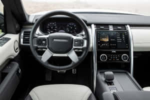 Sleek Land Rover Discovery Cruising On Highways Wallpaper