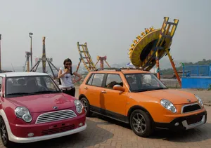 Sleek Lifan 320 Car In Vivid Red Color Wallpaper