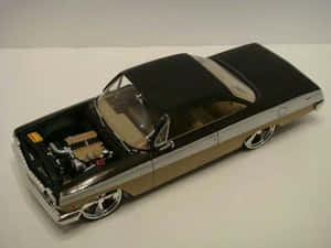 Sleek Luxury Car Model In Studio Setting Wallpaper