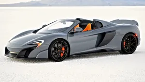 Sleek Mclaren 675lt Spider In Motion Wallpaper