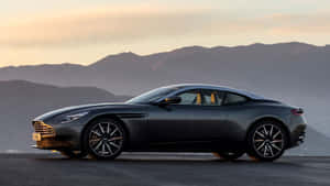 Sleek Metallic Gray Aston Martin Db11 On The Road Wallpaper
