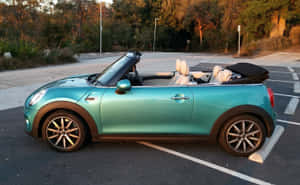 Sleek Mini Cooper Convertible Cruising On Open Road Wallpaper