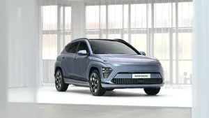 Sleek, Modern Electric Vehicle At Charging Station Wallpaper