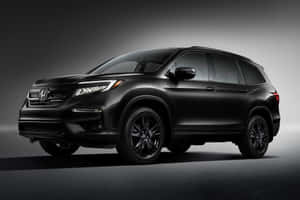 Sleek New Honda Pilot Suv On A Mountainous Road Wallpaper