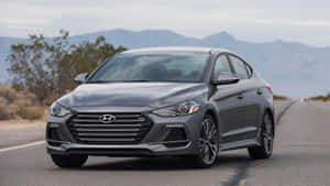 Sleek New Hyundai Elantra On A Scenic Highway Wallpaper