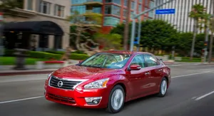 Sleek Nissan Altima At Sunset Wallpaper