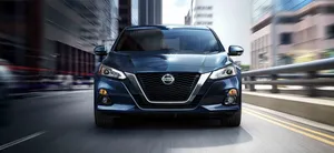 Sleek Nissan Altima On Scenic Drive Wallpaper