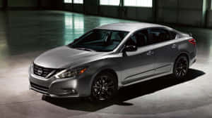 Sleek Nissan Altima Showcasing Its Dynamic Design On The Road Wallpaper