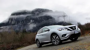 Sleek Nissan Murano Cruising Down A Beautiful Scenic Road Wallpaper