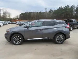 Sleek Nissan Murano Driving On Scenic Asphalt Road Wallpaper