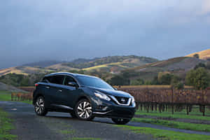 Sleek Nissan Murano On Concrete Road Wallpaper