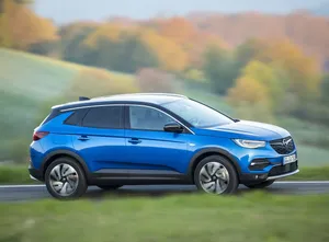 Sleek Opel Grandland X On A Scenic Landscape Wallpaper