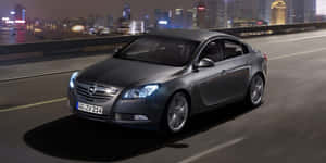 Sleek Opel Insignia In A Stunning City Backdrop Wallpaper