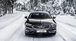 Sleek Opel Insignia Shining On The Road Wallpaper