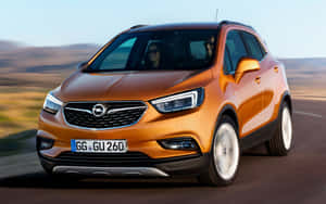 Sleek Opel Mokka Cruising Down The Highway Wallpaper