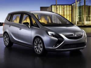Sleek Opel Zafira Driving On A Scenic Highway Wallpaper