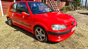 Sleek Peugeot 106 In Urban Landscape Wallpaper