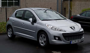 Sleek Peugeot 207 In Urban Settings Wallpaper
