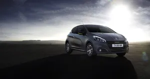 Sleek Peugeot 208 In Natural Setting Wallpaper