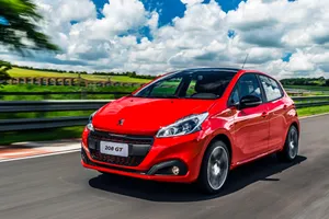 Sleek Peugeot 208 On Urban Road Wallpaper
