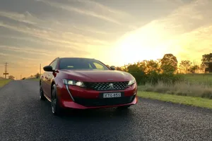 Sleek Peugeot 508 Gliding Through City Streets Wallpaper