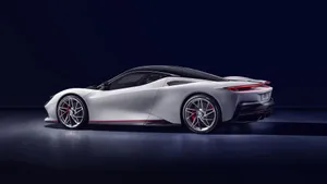 Sleek Pininfarina Sports Car On Asphalt Road Wallpaper