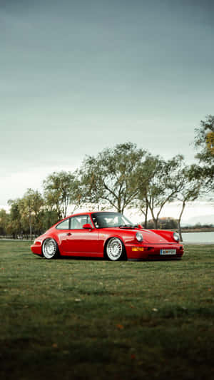 Sleek Porsche And Iphone Fusion Wallpaper Wallpaper