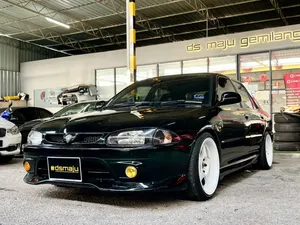 Sleek Proton Wira In Motion On A Smooth Highway Wallpaper