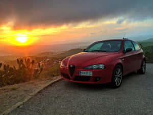 Sleek Red Alfa Romeo 147 In A Stunning Urban Setting Wallpaper