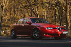 Sleek Red Alfa Romeo 156 In Action Wallpaper