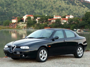 Sleek Red Alfa Romeo 156 On The Road Wallpaper