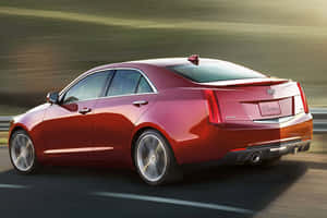 Sleek Red Cadillac Ats On Open Road Wallpaper