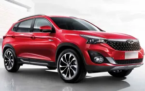 Sleek Red Chery Car On A Scenic Road Wallpaper