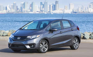 Sleek Red Compact Car On The Highway Wallpaper