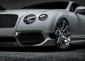 Sleek Red Convertible Cruising On A Scenic Road Wallpaper