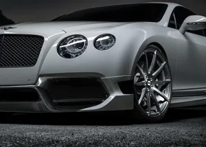 Sleek Red Convertible Cruising On A Scenic Road Wallpaper